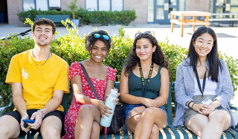 Students sitting on a bench.