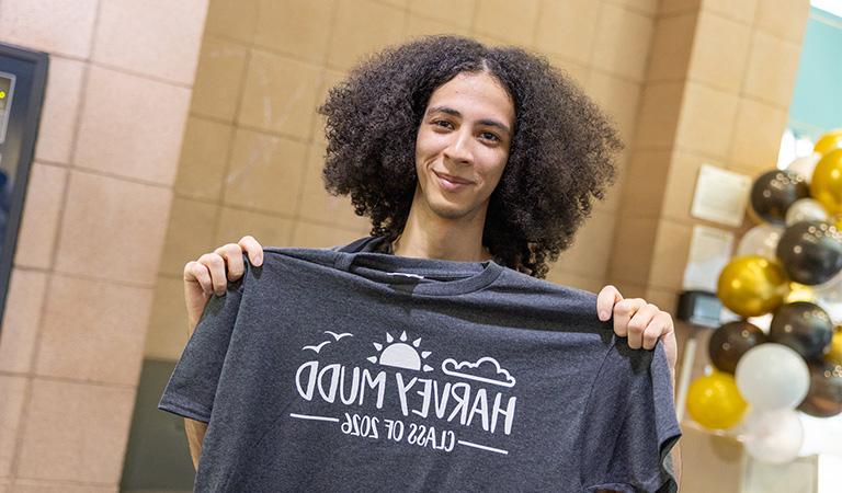 Student holding gray Class of 2026 t-shirt